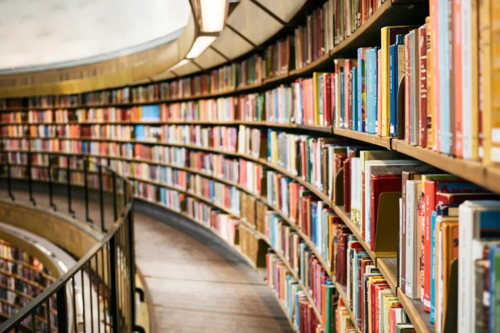 A row of curved library shelving on a balcony